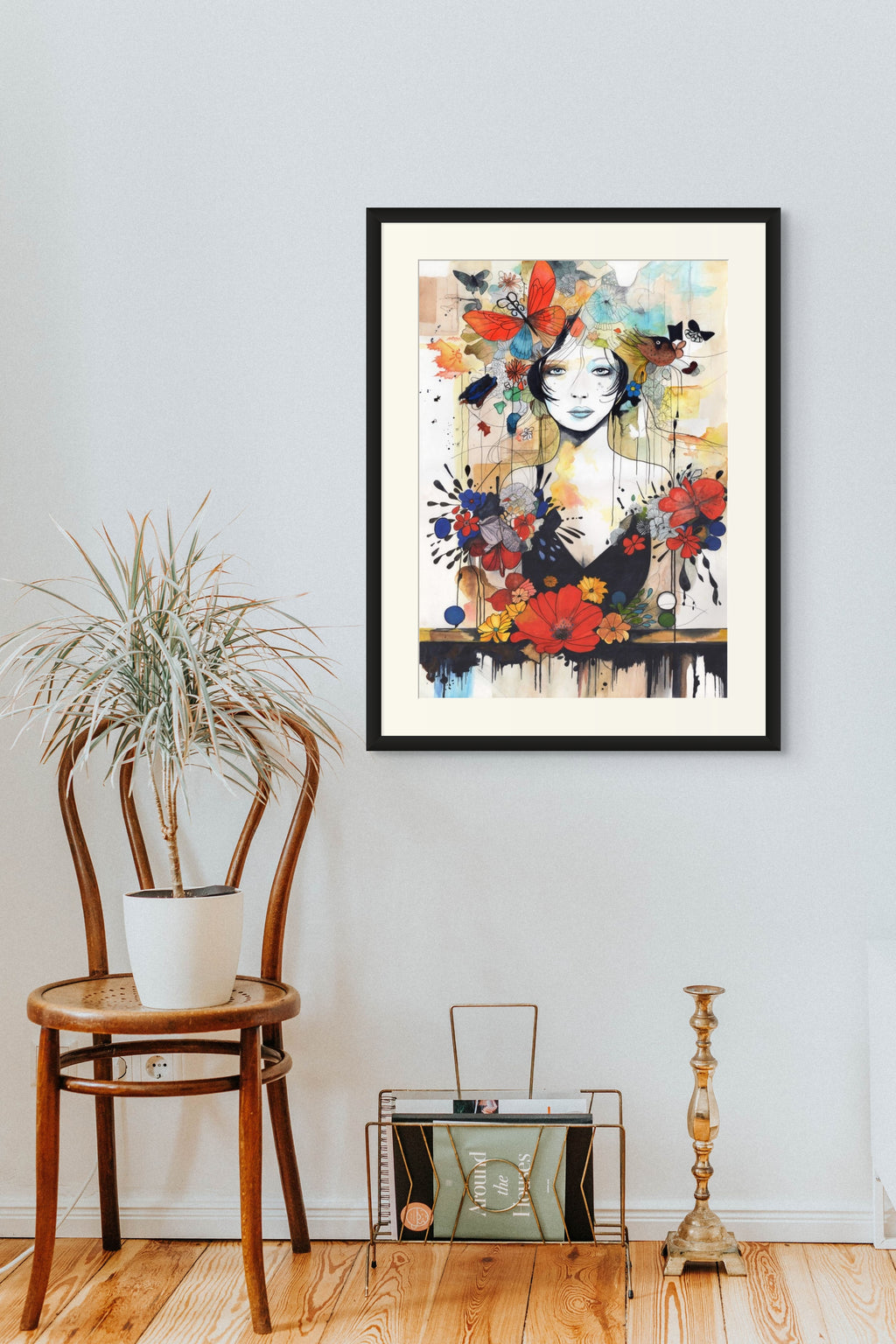 Framed contemporary art nouveau piece on a wall with a chair and decorative items below.