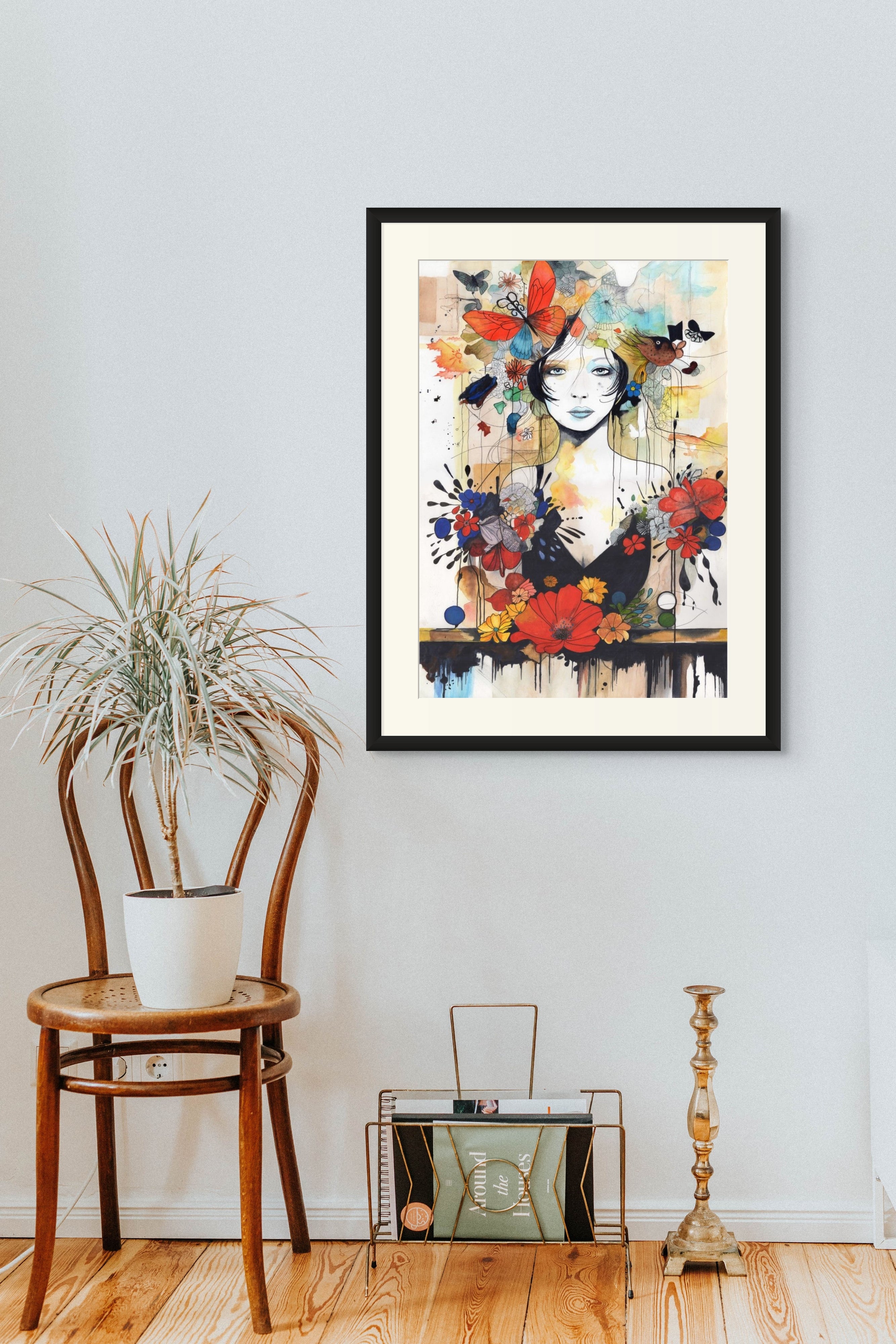 Framed contemporary art nouveau piece on a wall with a chair and decorative items below.